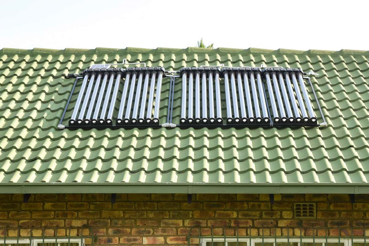 Solar geyser retrofit panels installed on a green tiled roof in Gauteng
